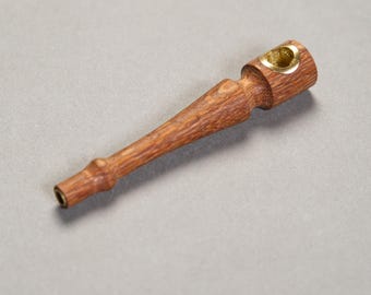 May include: A wooden smoking pipe with a brass bowl. The pipe is brown and has a smooth finish.