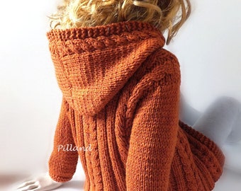 May include: A hand-knitted orange hooded sweater with a cable knit pattern. The sweater is made by Pilland.