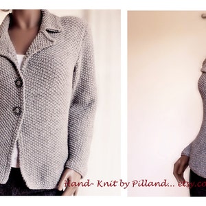 May include: A gray knitted cardigan with a collar and button closure. The cardigan is shown on a mannequin.