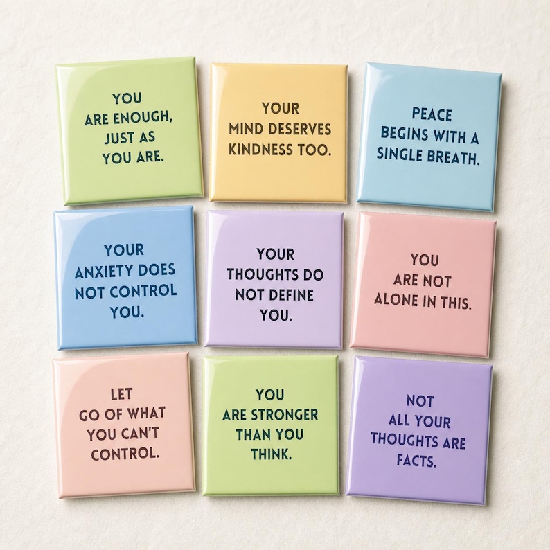 May include: A set of nine square magnets in pastel colors including light green, yellow, blue, lavender, and pink. Each magnet features black text with positive affirmations such as You Are Enough, Your Mind Deserves Kindness, and Peace Begins With A Single Breath.