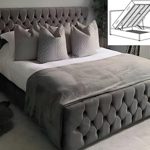 May include: A grey upholstered bed frame with a tufted headboard and a storage compartment that lifts up. The bed is made with a diamond-shaped pattern.