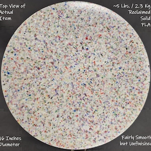 May include: A round, unfinished, solid PLA item with a diameter of 16 inches. The item is fairly smooth and reclaimed, weighing approximately 5 lbs. The surface is speckled with various colors, including red, blue, and green.