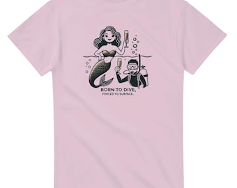 May include: Pink t-shirt with a black and white illustration of a mermaid and a scuba diver holding glasses of champagne. The text "Born to Dive, Forced to Surface." is printed below the illustration.