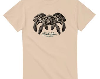 May include: A beige t-shirt with a graphic of three sea turtles and the text "Think blue, go green!"