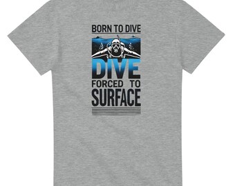 May include: Gray t-shirt with a blue and white graphic of a scuba diver. The text on the shirt reads "Born to Dive Dive Forced to Surface".
