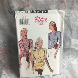 May include: Vintage sewing pattern for a women's blouse. The pattern is from Butterick and is called "Retro '44". The pattern shows three different styles of blouses with a wrap design. The pattern is for sizes 6-8-10.