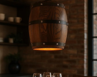 May include: A wooden barrel-shaped pendant light fixture with dark metal bands and rivets. The light hangs above a wooden table with wine glasses and a bowl. The warm light shines from the bottom of the fixture.