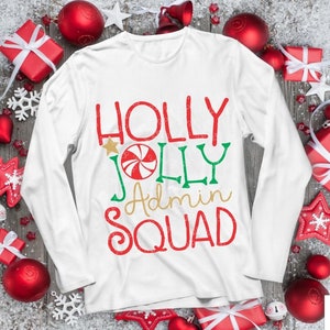 May include: White long-sleeve shirt with a Christmas-themed design that says "Holly Jolly Admin Squad" with a candy cane graphic.