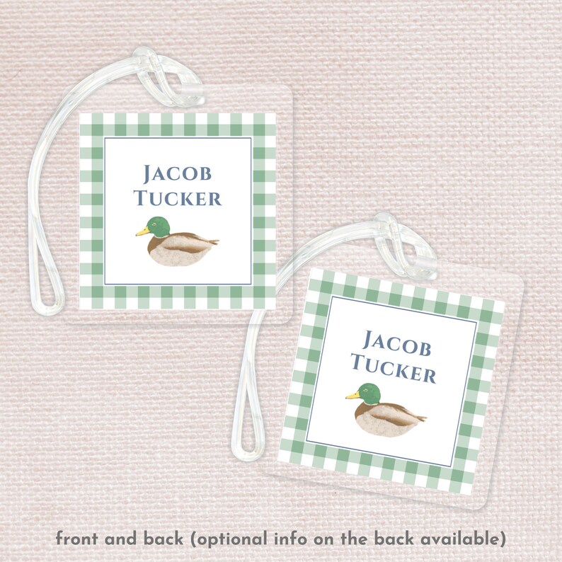 May include: Green and white gingham luggage tag with a duck illustration and the text "JACOB TUCKER" on the front and back.