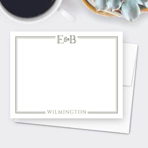 May include: White stationery with a green border and the initials "E&B" at the top. The word "WILMINGTON" is centered at the bottom. The stationery is on top of a white envelope.
