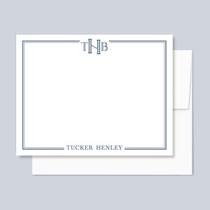 May include: A white rectangular stationery card featuring a dark blue double-line border. The top center displays the monogram THB in a serif font, while the bottom center features the name TUCKER HENLEY printed in a matching dark blue serif font.