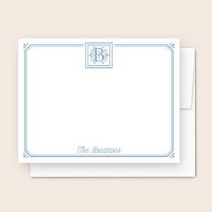 May include: White stationery set with a light blue border and a matching envelope. The stationery features a monogram in a square frame and the name "The Beachtons" in script.