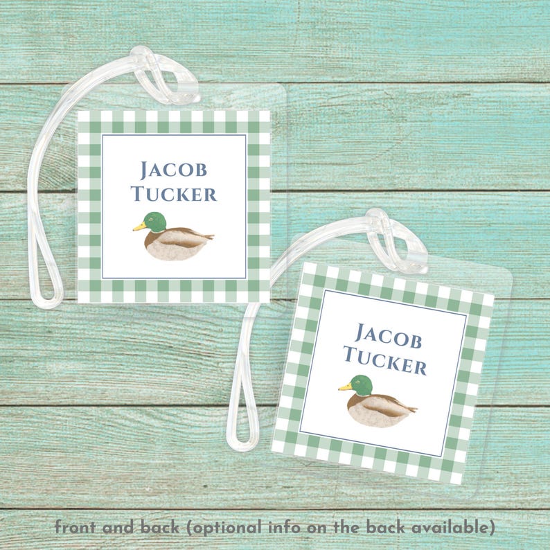 May include: Green and white gingham luggage tag with a blue duck illustration and the name "Jacob Tucker" printed in blue text.