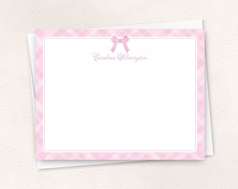 May include: Pink and white stationery with a pink bow and the name "Carolina Wilmington" printed on the top.