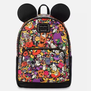 May include: A black backpack with two rounded ears on top, featuring a colorful all-over print of Disney characters in Halloween costumes, pumpkins, ghosts, and candy. A black metal plaque with the text Disney Parks Loungefly is on the front.