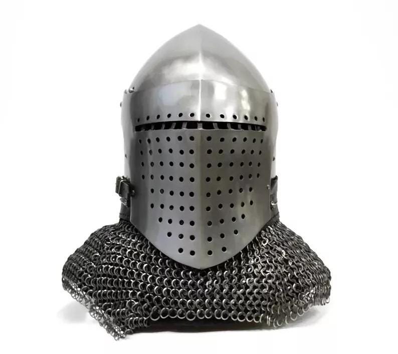 May include: A silver-colored medieval helmet with a rounded top and a faceplate covered in small holes. The helmet includes a chainmail neck guard. The design is reminiscent of historical armor.