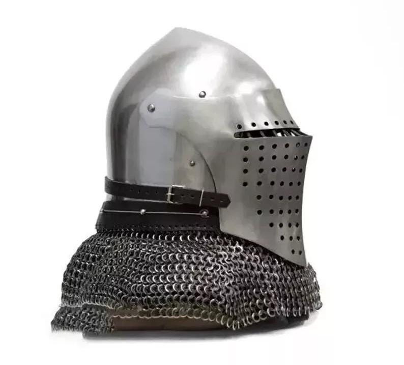 May include: A polished steel medieval helmet with a riveted visor and a leather strap. The helmet features a series of small holes for ventilation and is attached to a chainmail coif. The design is reminiscent of historical armor.