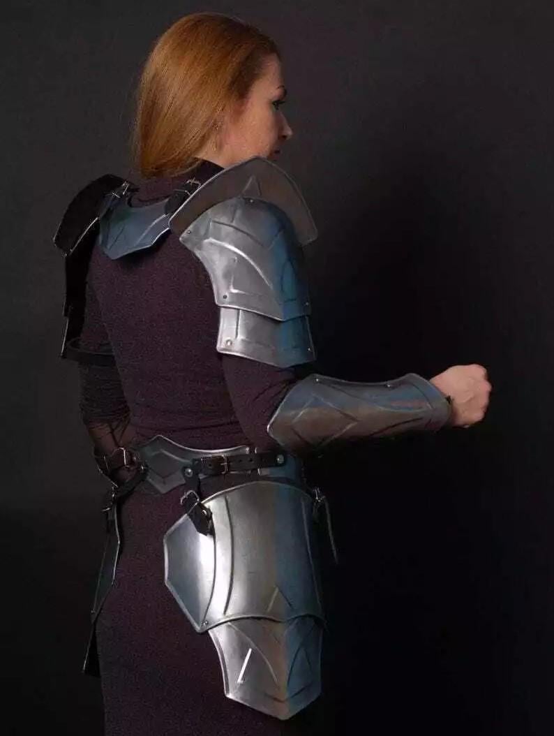 May include: A silver metal armor set for the shoulders, arms, and hips. The armor is made of metal plates and has a sleek, modern design.