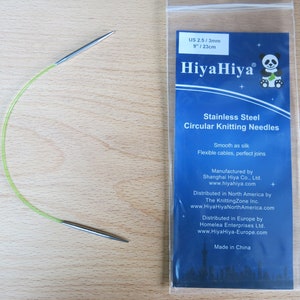 May include: A HiyaHiya 9-inch (23 cm) circular knitting needle with a green cable and stainless steel tips. The needle size is US 2.5/3 mm. The packaging includes information about the product and the manufacturer.