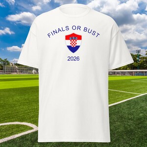 May include: White t-shirt with the text "Finals or Bust" and the Croatian coat of arms. The year 2026 is printed below the coat of arms.