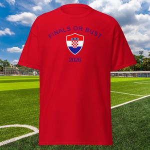 May include: Red t-shirt with a blue and white Croatian flag crest and the text "FINALS OR BUST 2026" in blue.