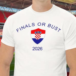 May include: White t-shirt with the text "FINALS OR BUST" in blue, a Croatian flag shield, and the year "2026" in blue.