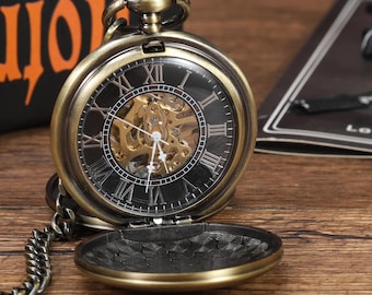 May include: Antique bronze pocket watch with a skeleton dial, Roman numerals, and a chain. The watch face is visible through a clear cover, showcasing the intricate inner workings. The watch is open, revealing the detailed design.