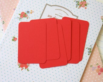 May include: Five red blank note cards with rounded corners on a white background with blue polka dots and a floral pattern.