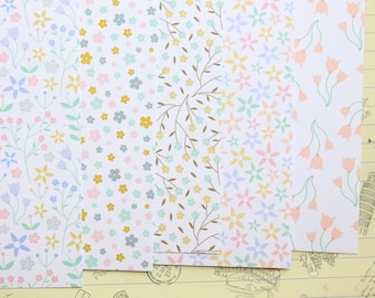 May include: Five sheets of decorative paper with different floral patterns. The patterns include small flowers, leaves, and larger flowers. The colors are pastel pink, blue, green, and yellow.