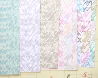 May include: Six sheets of decorative paper with a repeating pattern of white outlined leaves on different colored backgrounds. The colors are light blue, lavender, light gray, light pink, light blue, and light green.