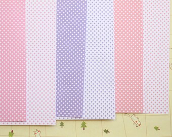 May include: Five sheets of patterned paper with white polka dots on a pink, light pink, purple, lavender, and peach background.