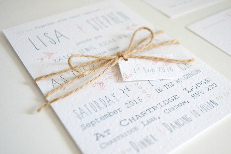 May include: A wedding invitation with a rustic theme. The invitation is tied with twine and features the names "LISA & STERNEN" and the date "SATURDAY 3rd SEPTEMBER 2016".