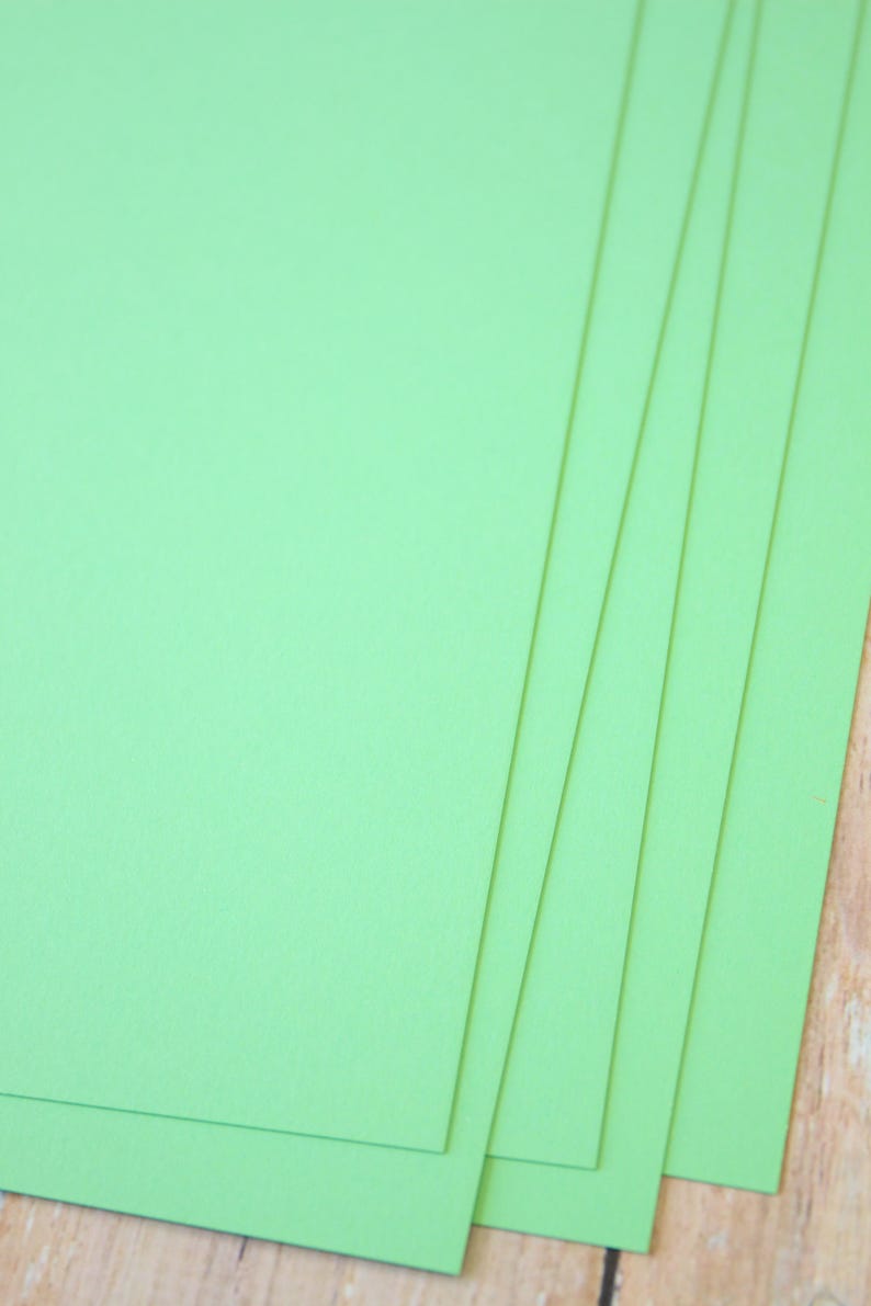 May include: Stack of five bright green sheets of cardstock paper.