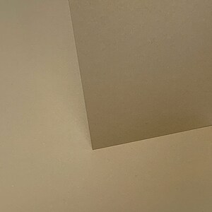 May include: A close-up of a corner where two walls meet. The walls are painted a light beige color.