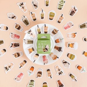 May include: A set of 30 colorful stickers featuring various bubble tea designs. The stickers are arranged in a circle around a small box of tea. The box is labeled "Vitality Milk Tea" in English and Chinese.