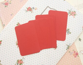 May include: Five blank cards with rounded corners, arranged in a fan shape on a white background with a floral pattern.