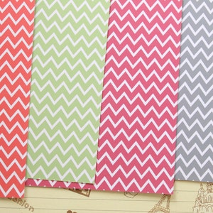 Pode incluir: Quatro folhas de papel com um padr&atilde;o de chevron. As folhas s&atilde;o nas cores vermelho, verde, rosa e cinza.