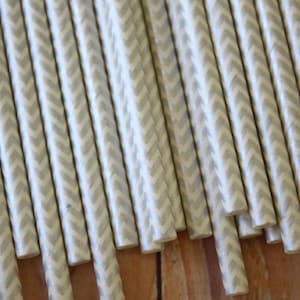May include: A bundle of white paper straws with a grey chevron pattern.