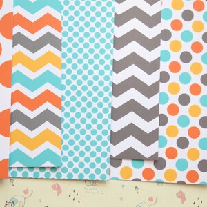 May include: Six sheets of patterned paper with different designs. The designs include orange polka dots, gray and yellow chevron, teal polka dots, gray chevron, orange, teal, and yellow polka dots, and orange chevron.