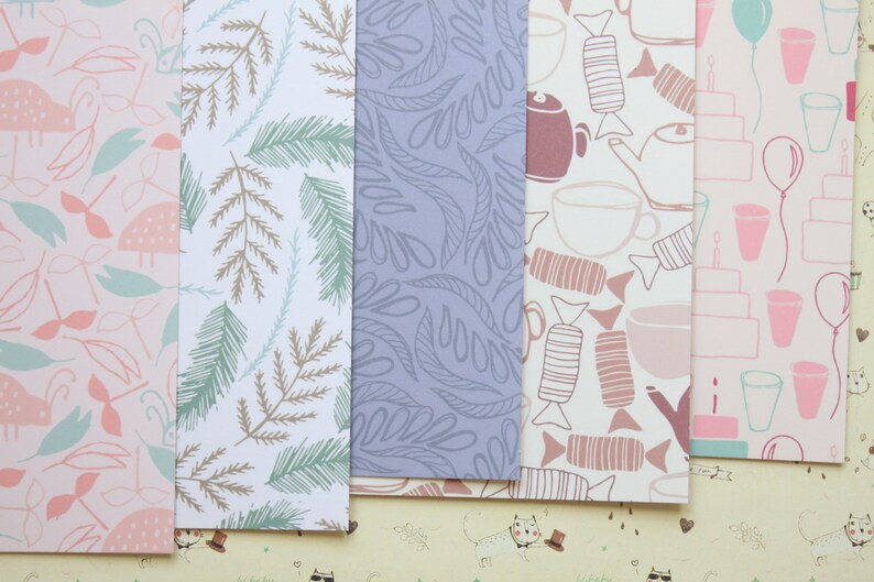 May include: Five different patterned sheets of wrapping paper. The patterns include pink and green birds, brown and green leaves, blue leaves, brown and pink teacups and candy, and pink and blue balloons and cakes.