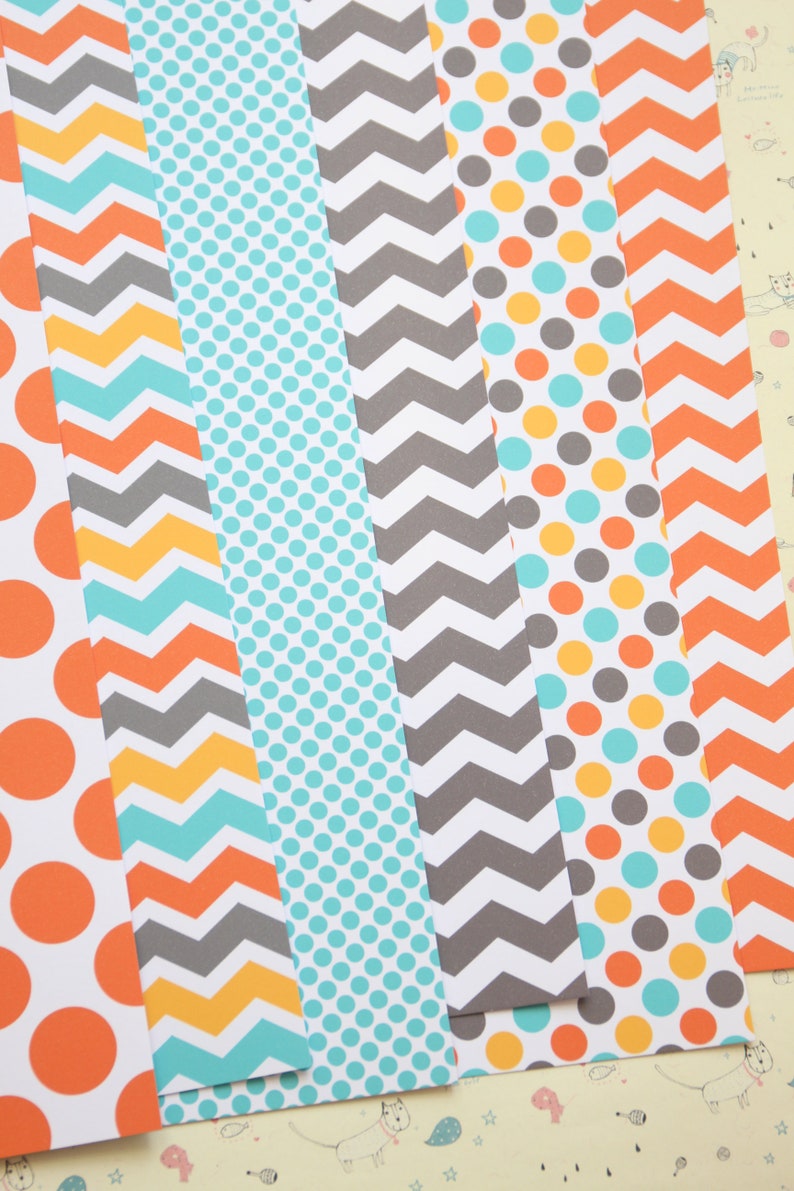 May include: Six strips of patterned paper with different designs. The patterns include orange and white polka dots, gray and turquoise chevron, turquoise polka dots, gray and white chevron, orange, turquoise, and gray polka dots, and orange and white chevron.
