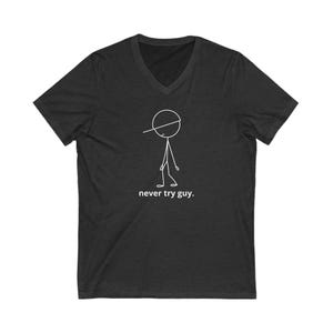 May include: A dark gray V-neck t-shirt with a stick figure wearing a hat and the text "never try guy."