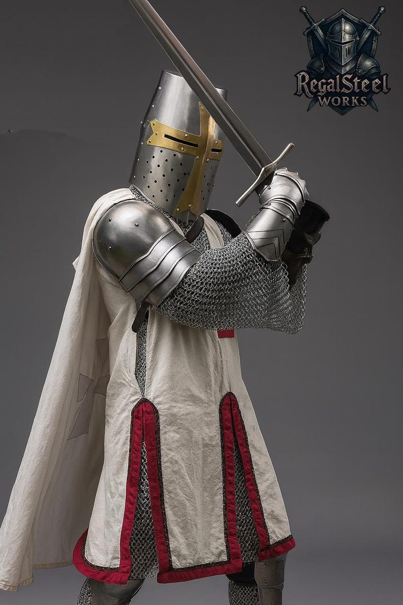 May include: A knight in full armor, holding a long sword. The helmet is silver with a gold cross, and the armor includes a chainmail shirt and shoulder guards. The white tunic has red trim and a cross emblem. The Regal Steel Works logo is visible.
