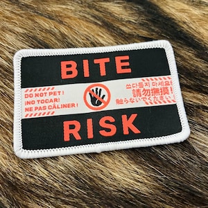 May include: A white ceramic mug with a black handle and the text "But First, Coffee" in a black, bold font. The mug is on a white surface.