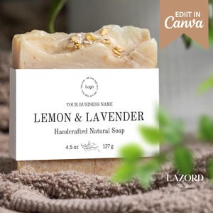 Puede incluir: Una etiqueta blanca con texto negro dice "YOUR BUSINESS NAME", "LEMON & LAVENDER", "Jabón natural artesanal", "4,5 oz" y "127 g". Se puede ver una barra de jabón con motas doradas detrás de la etiqueta.