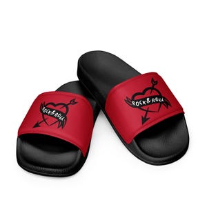 May include: Pair of red and black slides with a black heart with an arrow through it and the text "Rock & Roll" on a white banner.