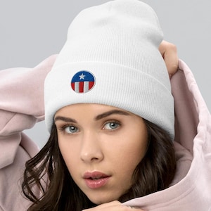 May include: White beanie with a red, white, and blue star and stripes circle embroidered on the front.