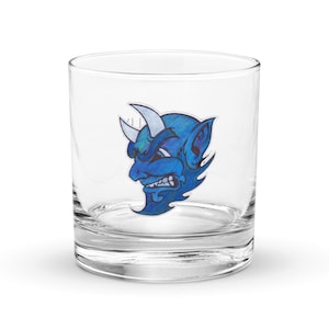 May include: A clear glass tumbler with a blue and white illustration of a devil's face on the front.