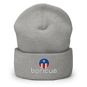 May include: A gray beanie with a folded brim. The beanie features an embroidered emblem with a blue star, red and white stripes, and the word "boricua" in white script.