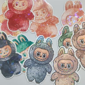 Pegatinas de vinilo Labubu: adorable criatura con acabado holográfico, laminadas con estrellas, gemas o purpurina, impermeables y resistentes a la intemperie.